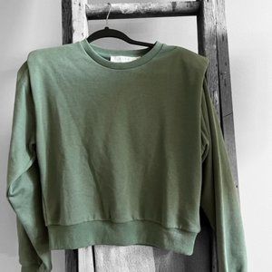 Green sweatshirt with exaggerated shoulders